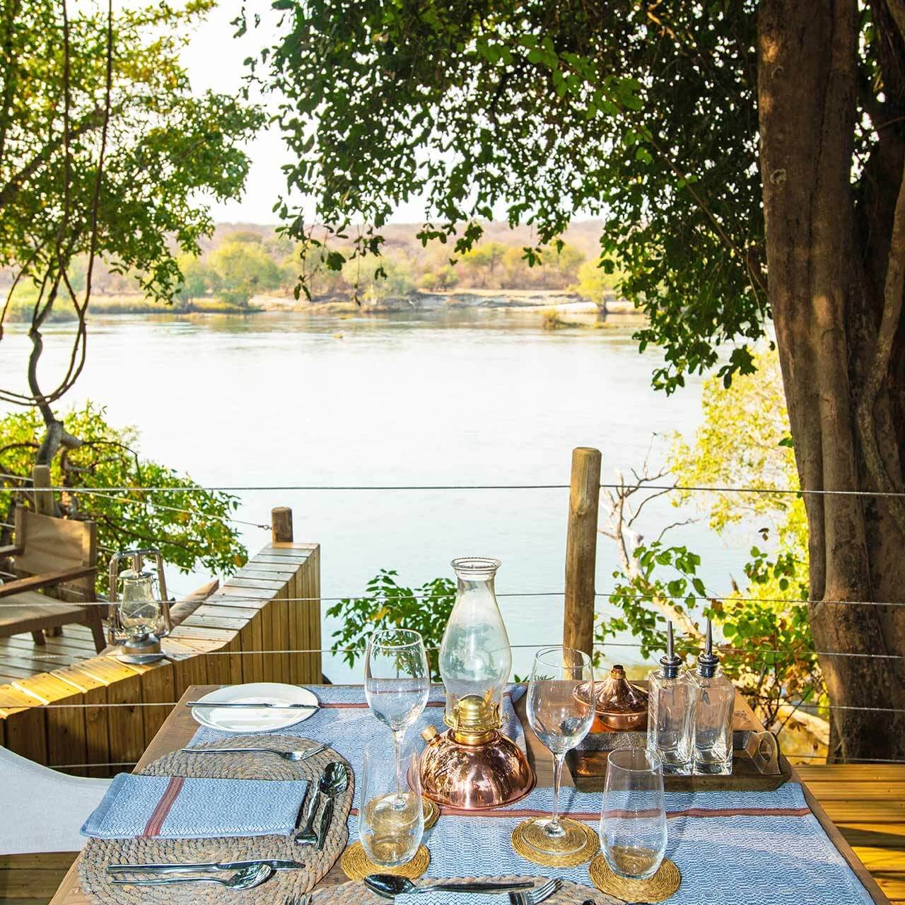 View of the Zambezi River from the dining area at Tsowa Luxury Safari Camp an Isbindi Africa Lodge Located in Zambezi National Park near Victoria Falls, Zimbabwe.